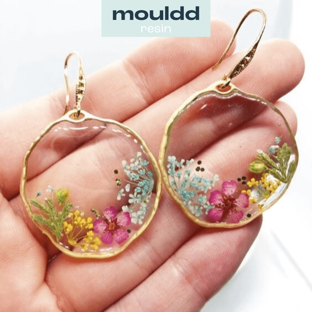 pair of small hanging resin earrings embedded with flowers